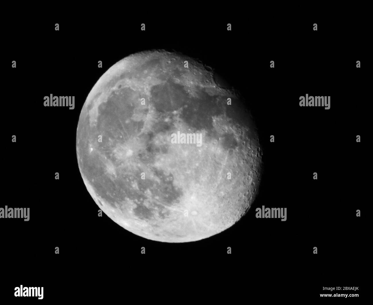 Waning gibbous moon in a dark sky Stock Photo
