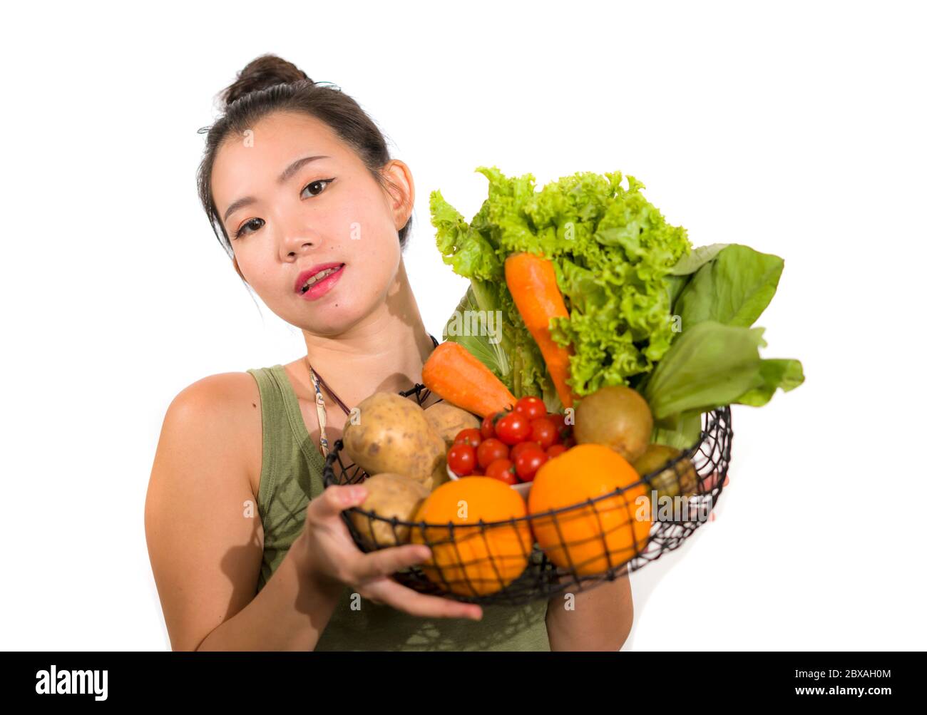 young happy and beautiful Asian Japanese woman holding basket full of ...