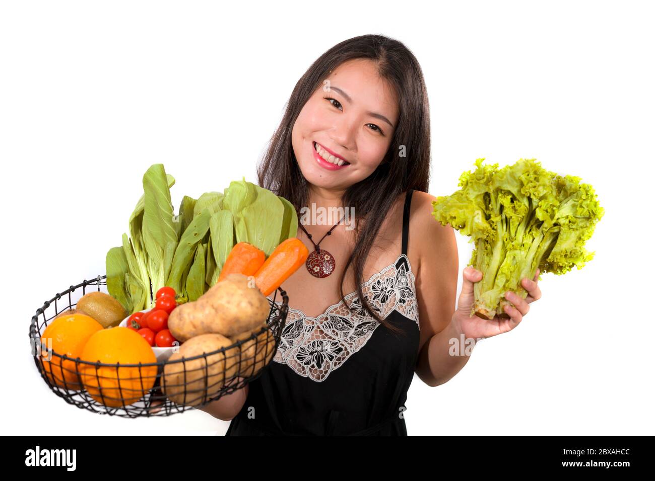 young happy and beautiful Asian Korean woman holding basket full of ...