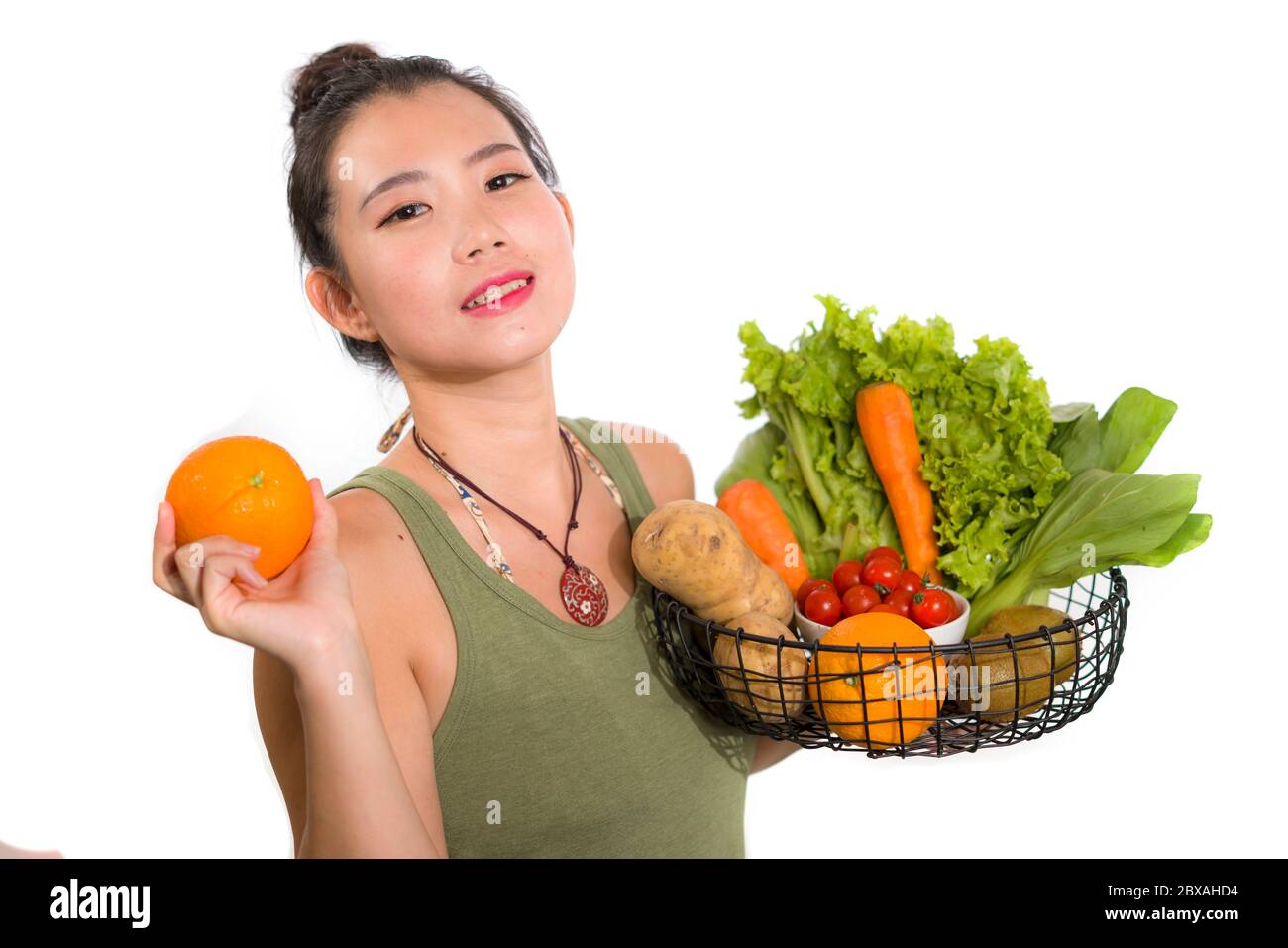 young happy and beautiful Asian Korean woman holding basket full of ...