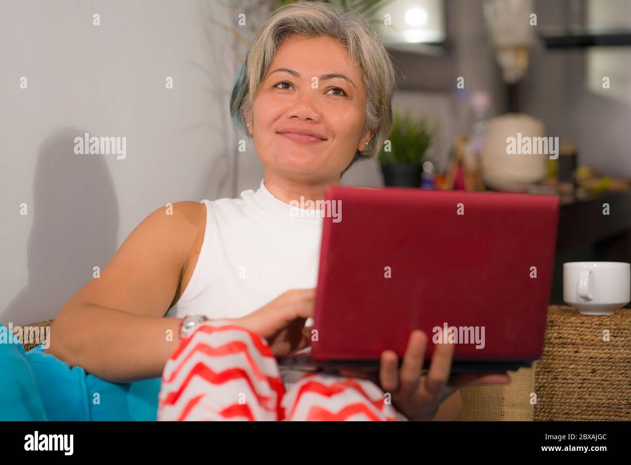 happy and beautiful middle aged woman on her 50s working on laptop ...