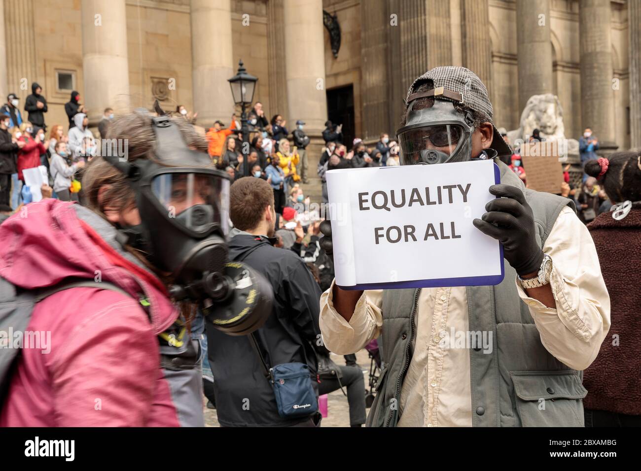 Protestors wearing respirators at black lives matter protest holding 'equality for all' sign. Saturday June 6th 2020, Leeds, West Yorkshire, England. Hundreds of people gather outside the city's town hall to protest against racism and violence towards BAME persons, following the death of George Floyd in the USA. ©Ian Wray/Alamy Stock Photo