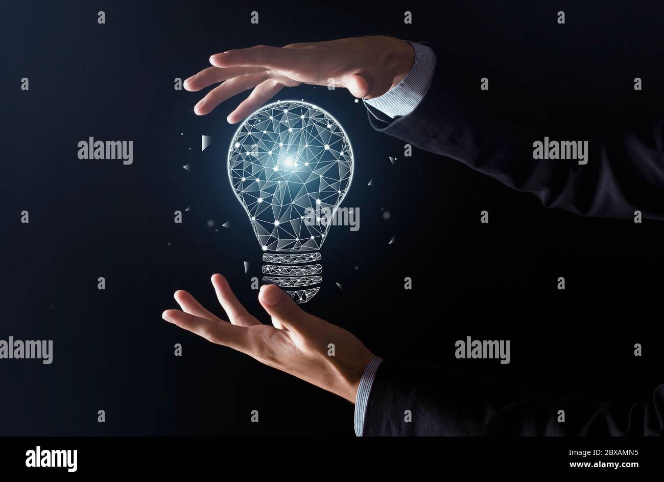 New ideas with innovation and creativity. Man hands do trick and glowing abstract light bulb appears Stock Photo