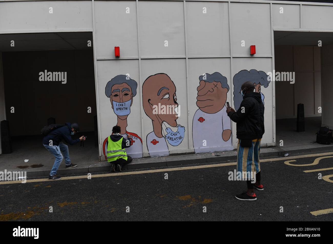People paint a mural as they take part in a Black Lives Matter protest rally in Custom House Square, Belfast, in memory of George Floyd who was killed on May 25 while in police custody in the US city of Minneapolis. Stock Photo