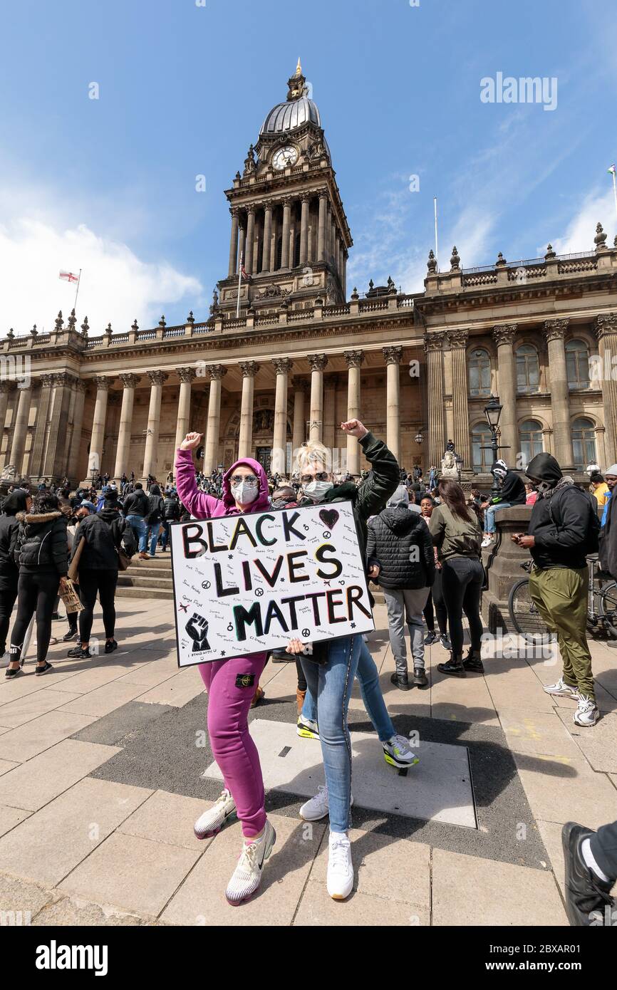 Uk White female protestors with black lives matter sign. Saturday June 6th 2020, Leeds, West Yorkshire, England. Hundreds of people gather outside the city's town hall to protest against racism and violence towards BAME persons, following the death of George Floyd in the USA. ©Ian Wray/Alamy Stock Photo