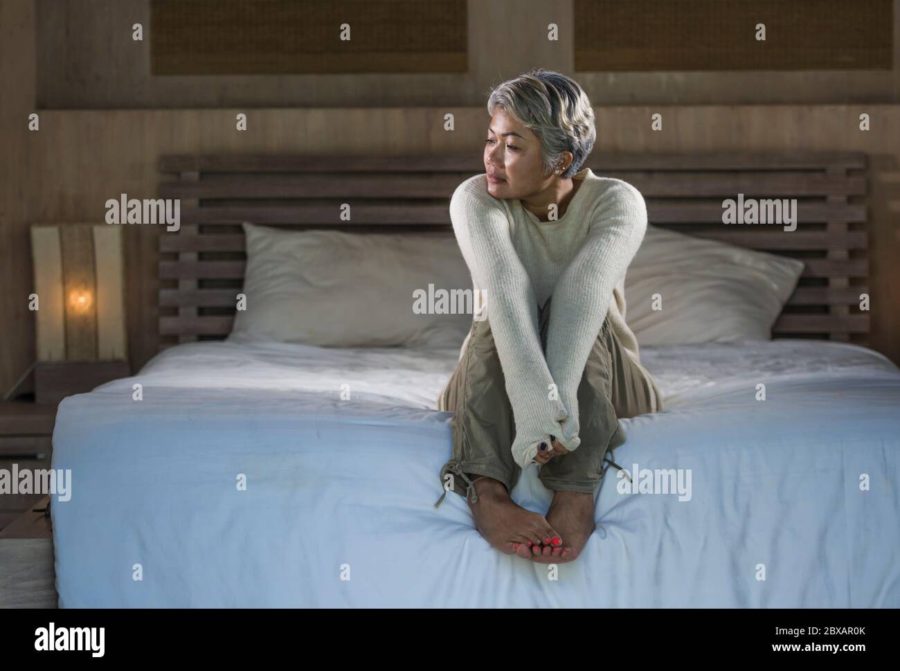 Asian woman crying in bed hi-res stock photography and images - Alamy