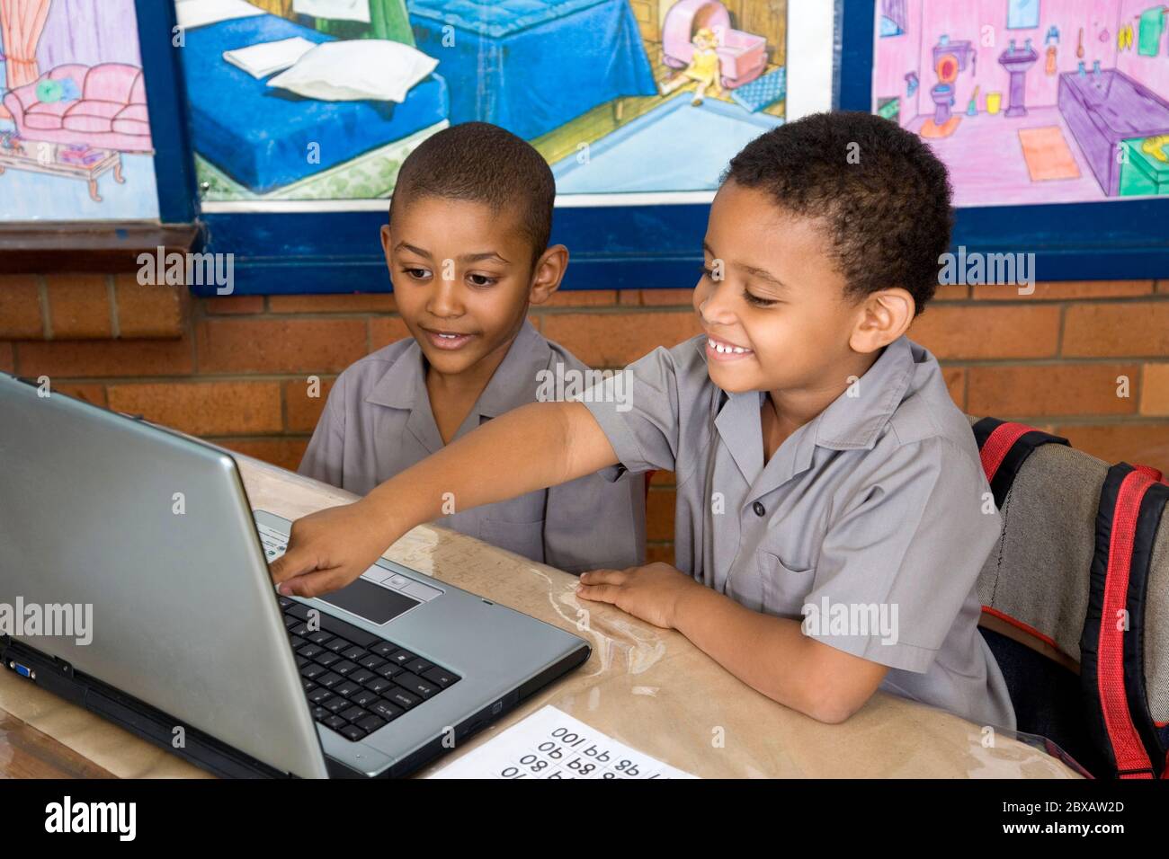 Kids using laptop computer in class Stock Photo - Alamy