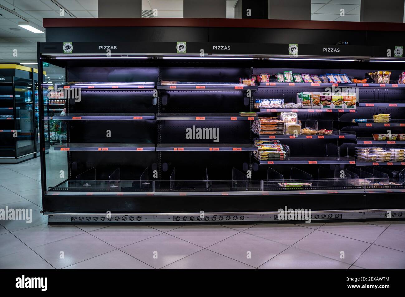 Coronavirus. Empty supermarket due to panic buying caused by COVID-19 crisis. Shortage of food and basic supplies on the shelves. Malaga, Spain - Marc Stock Photo