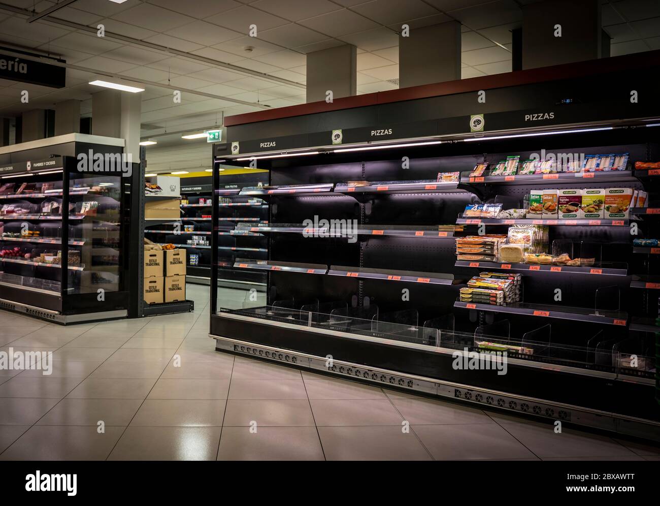 Coronavirus. Empty supermarket due to panic buying. Shortage of food and basic supplies on the shelves. Malaga, Spain - March 12, 2020. Stock Photo