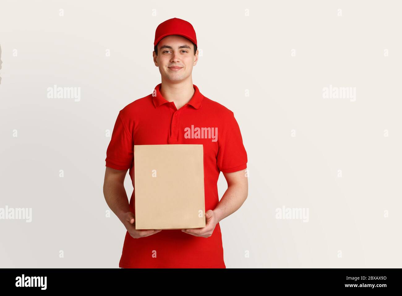 Courier job is deliver package to customer. Deliveryman holds cardboard box Stock Photo