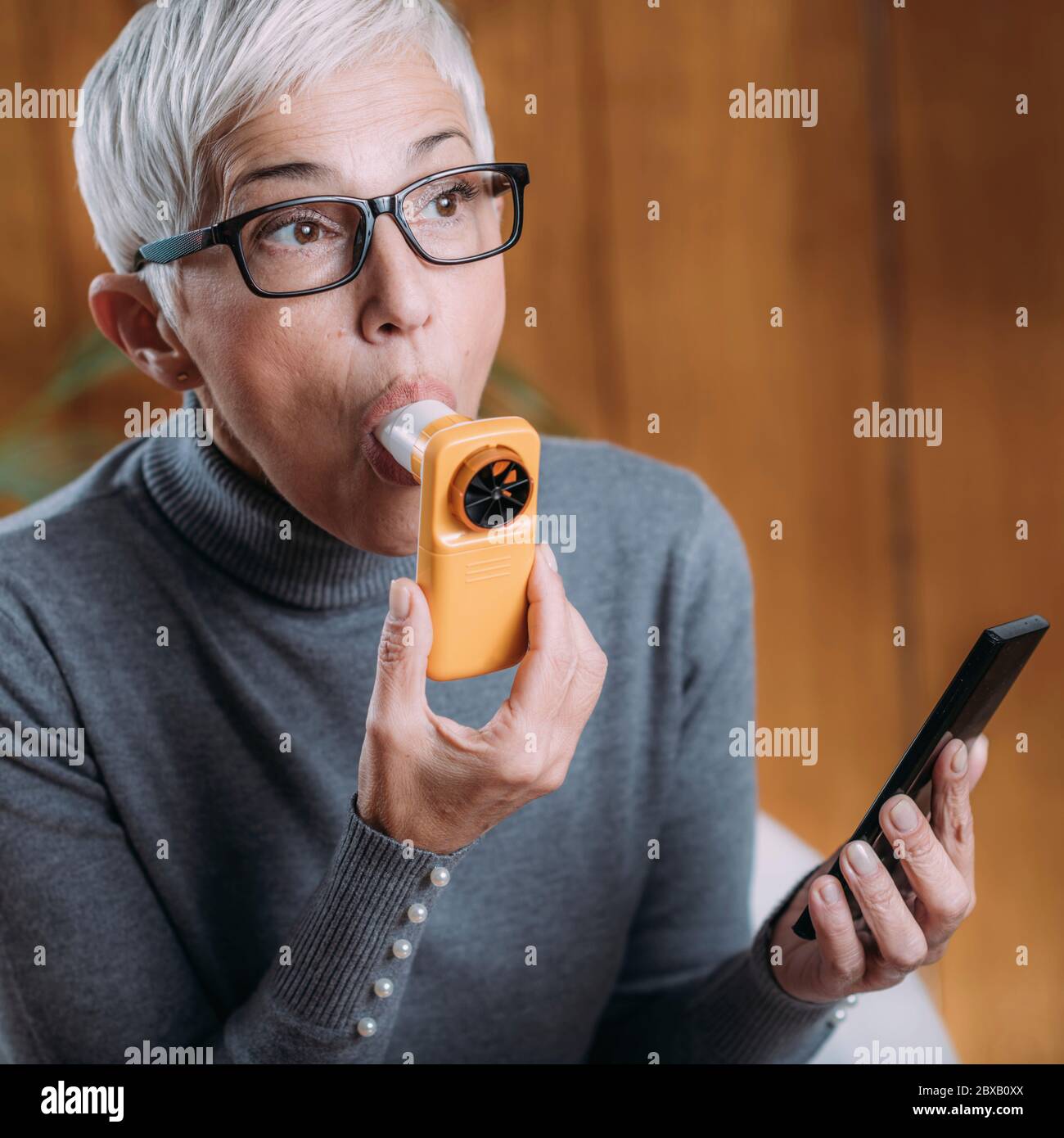 Spirometry using digital spirometer with smart phone app Stock Photo