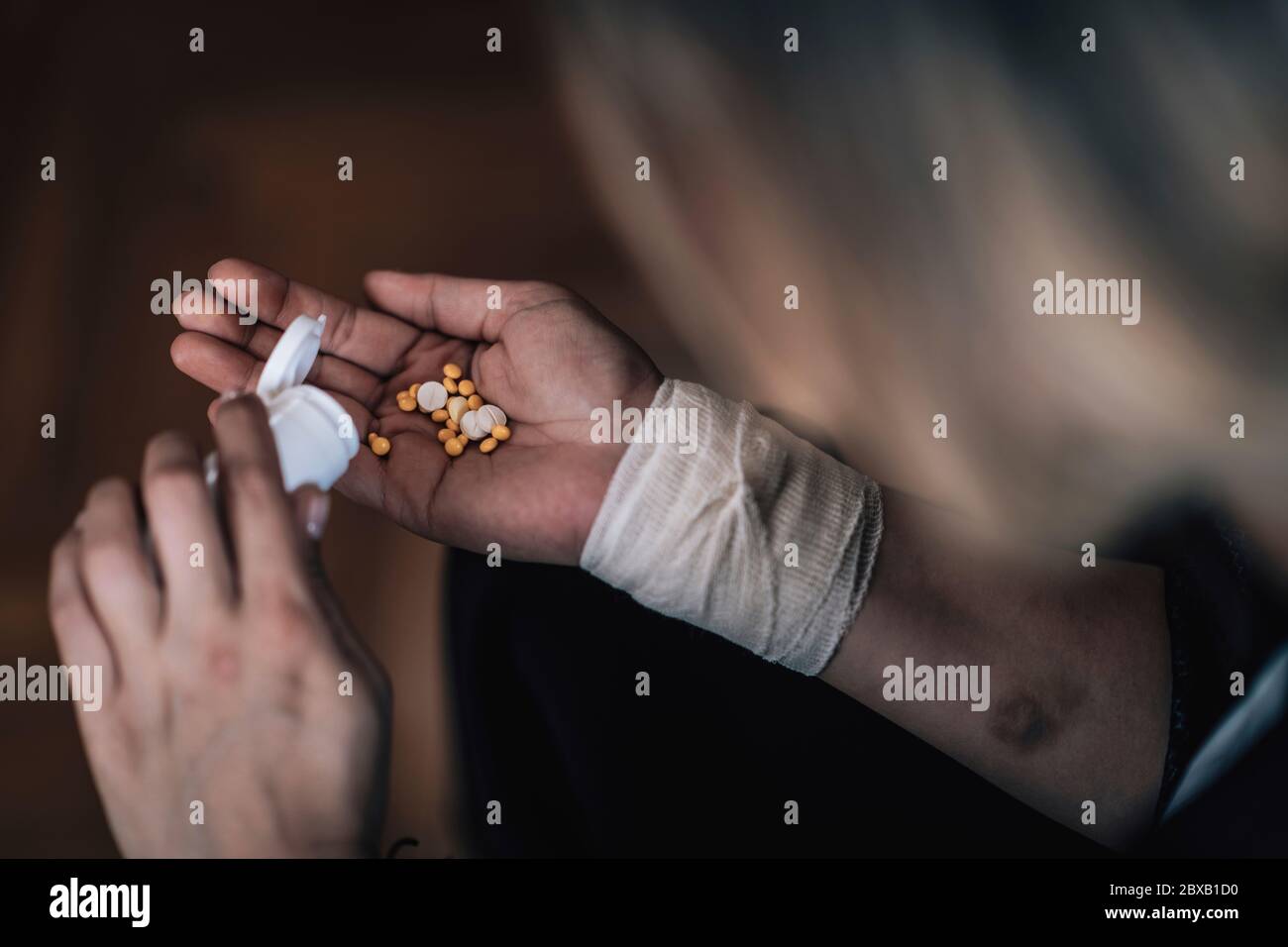 Suicidal mental health patient taking pills Stock Photo