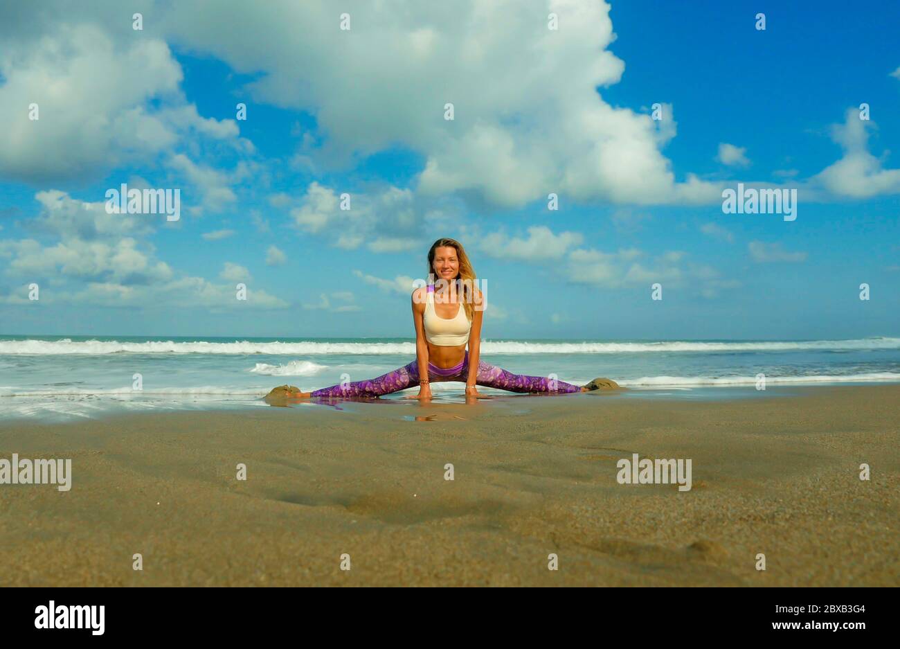 woman-practicing-yoga-at-beautiful-beach-young-happy-and-attractive