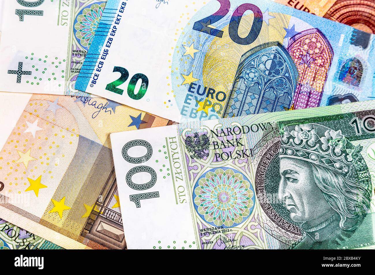 Scattered Polish Zloty PLN and Euro EUR currency notes Stock Photo