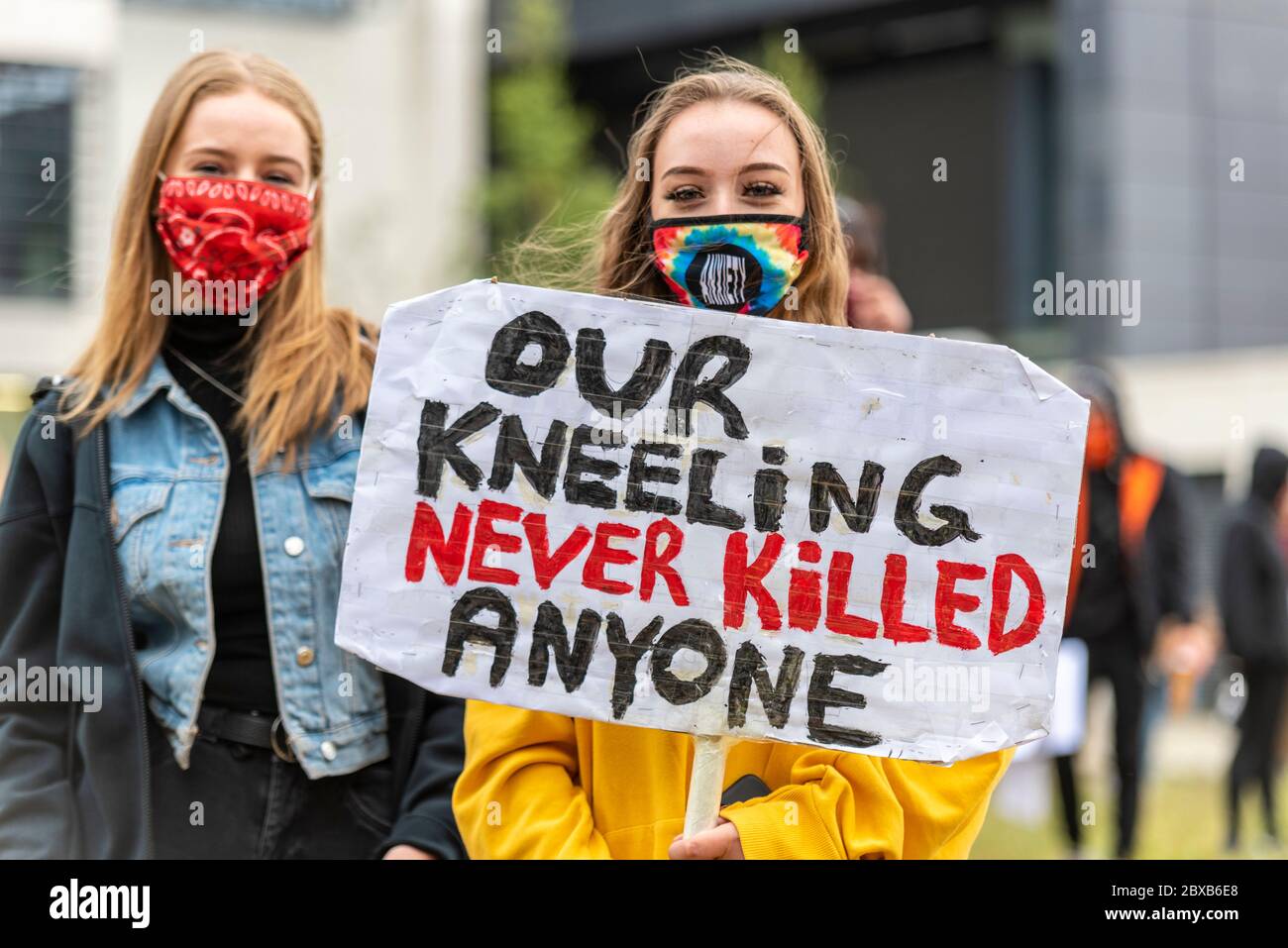 Black Lives Matter anti racism protest demonstration in Southend on Sea, Essex, UK. Young white, Caucasian females with placard, kneeling never killed Stock Photo