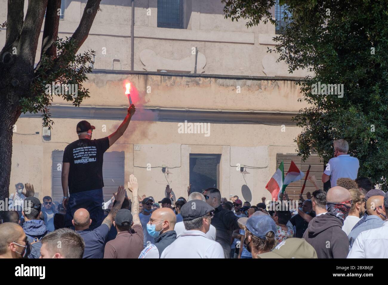 An extreme right-wing guy uses a smoke bomb at the populist demonstration of 'Ragazzi d'Italia' near Circo Massimo, Rome, Italy, June 6th, 2020 Stock Photo