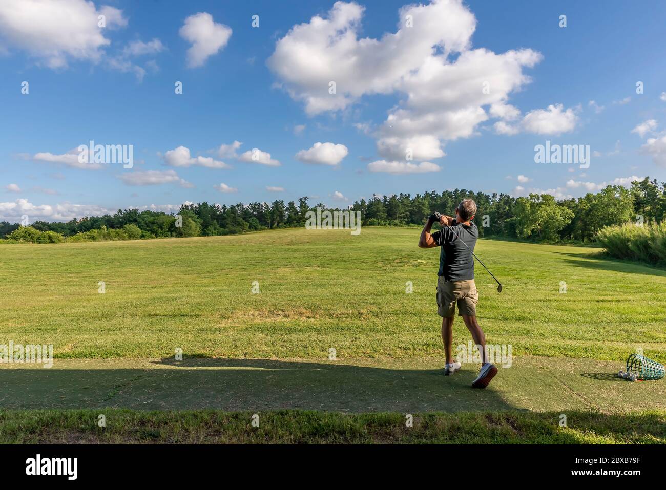 Golf player trains in a driving range completely immersed in the Tuscan  countryside near Pisa, Italy Stock Photo - Alamy