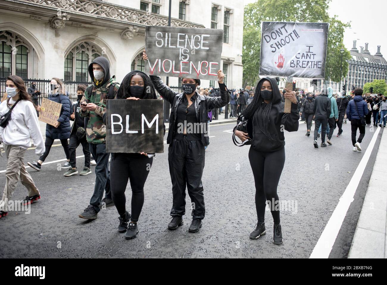 Black women hold placards during the anti racist protest against the killing of George Floyd in US. Stock Photo