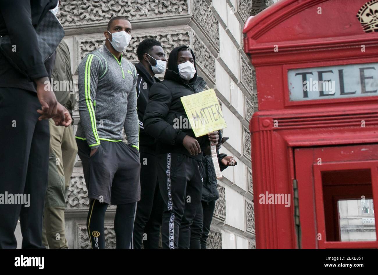 A group of young black men take part in the protest against systemic racism in the UK held in central London, UK. Stock Photo