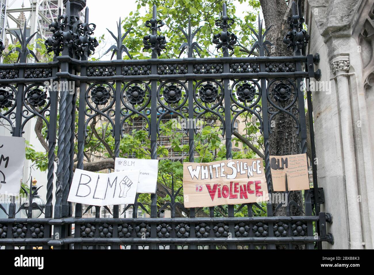 Placards are displayed on the Houses of Parliament railings during the rally in London, UK, against racism and the killing of George Floyd in US. Stock Photo