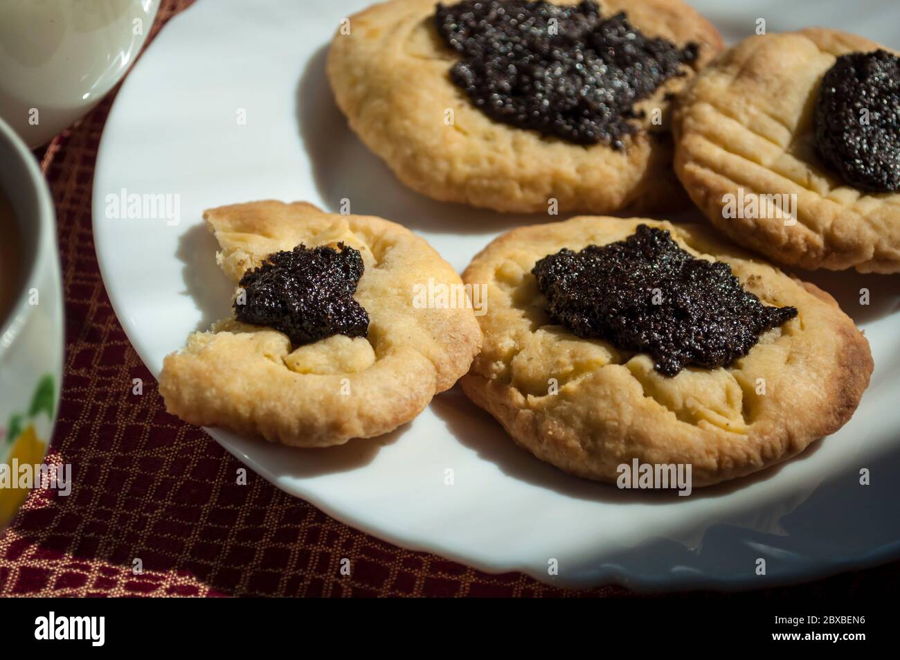 Bitten cookies with poppy seed filling in daylight, bakery background, food photography Stock Photo