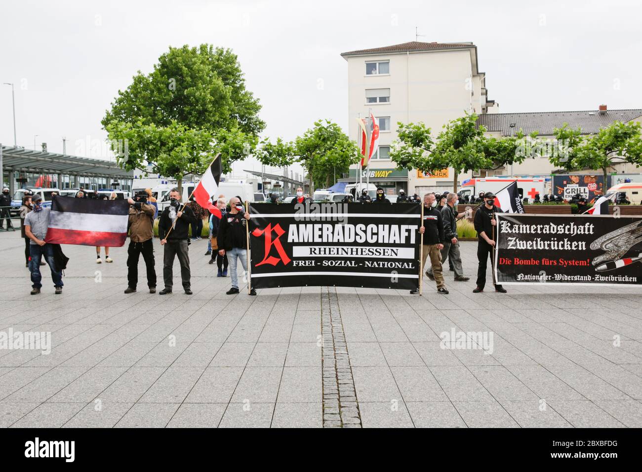 Worms, Germany. 6th June 2020. The right-wing protesters stand with flags and banners at the closing rally. Around 50 right-wing protesters marched through the city centre of Worms for the 12. and last 'Day of the German Future’. The march was cut short due to several hundred counter protesters who blocked the  path of the right-wing march. The march was a yearly right-wing event in different German city that drew over 1000 protesters at its high-point. Stock Photo