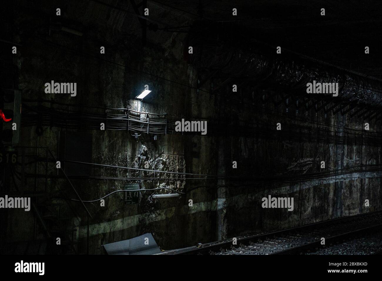 Empty underground train tunnel. Dark close-up subway station. Malaga, Spain - March 3, 2020. Stock Photo