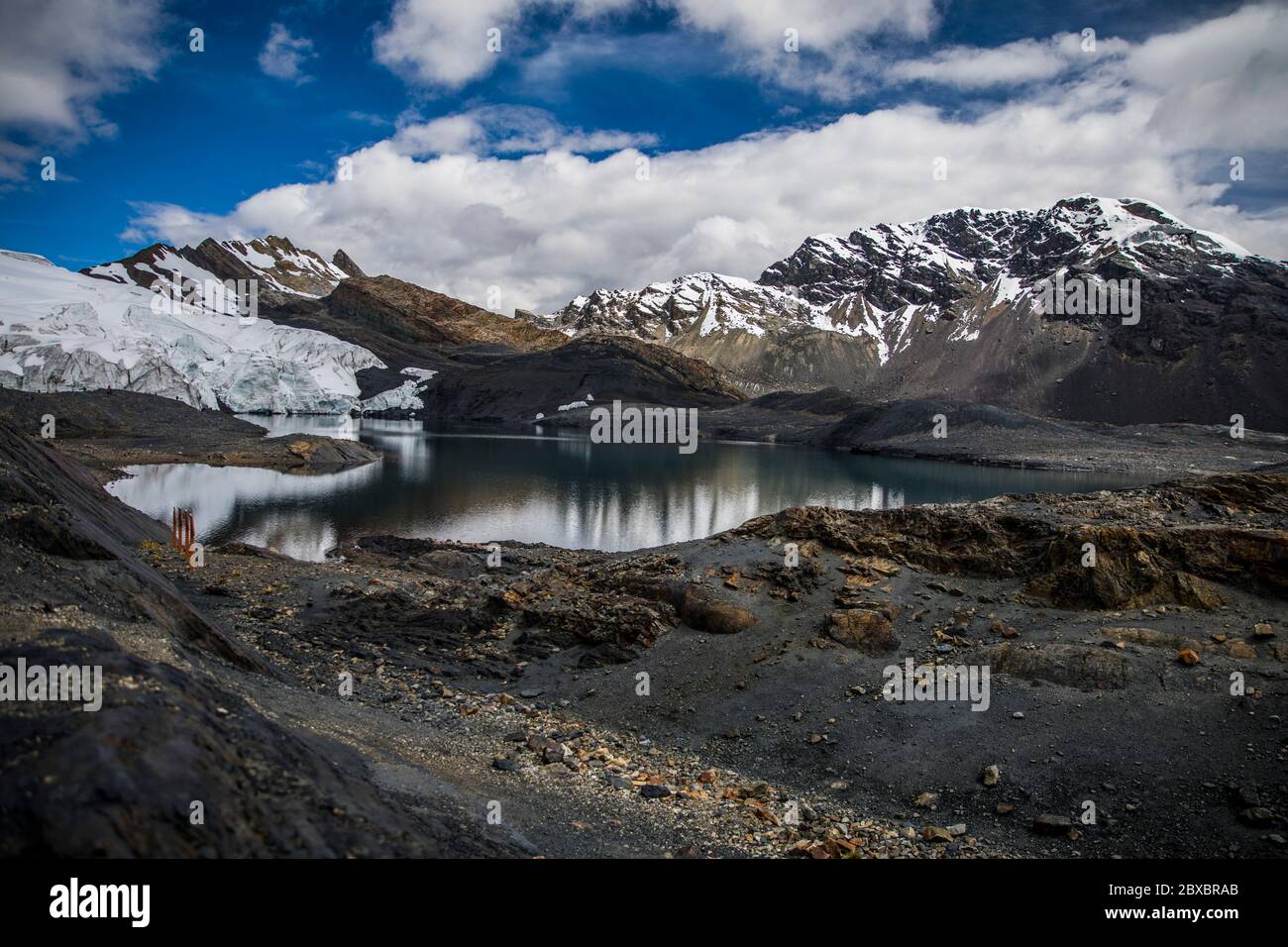 landscape with a glacier and snowy, beautiful lake, clouds and blue sky, no people Stock Photo