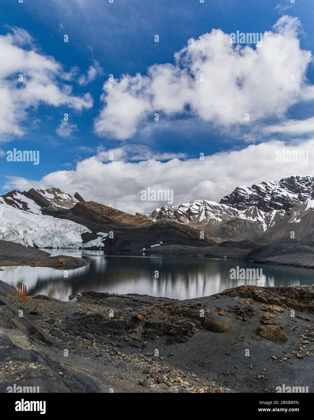 landscape with a glacier and snowy, beautiful lake, clouds and blue sky, no people Stock Photo