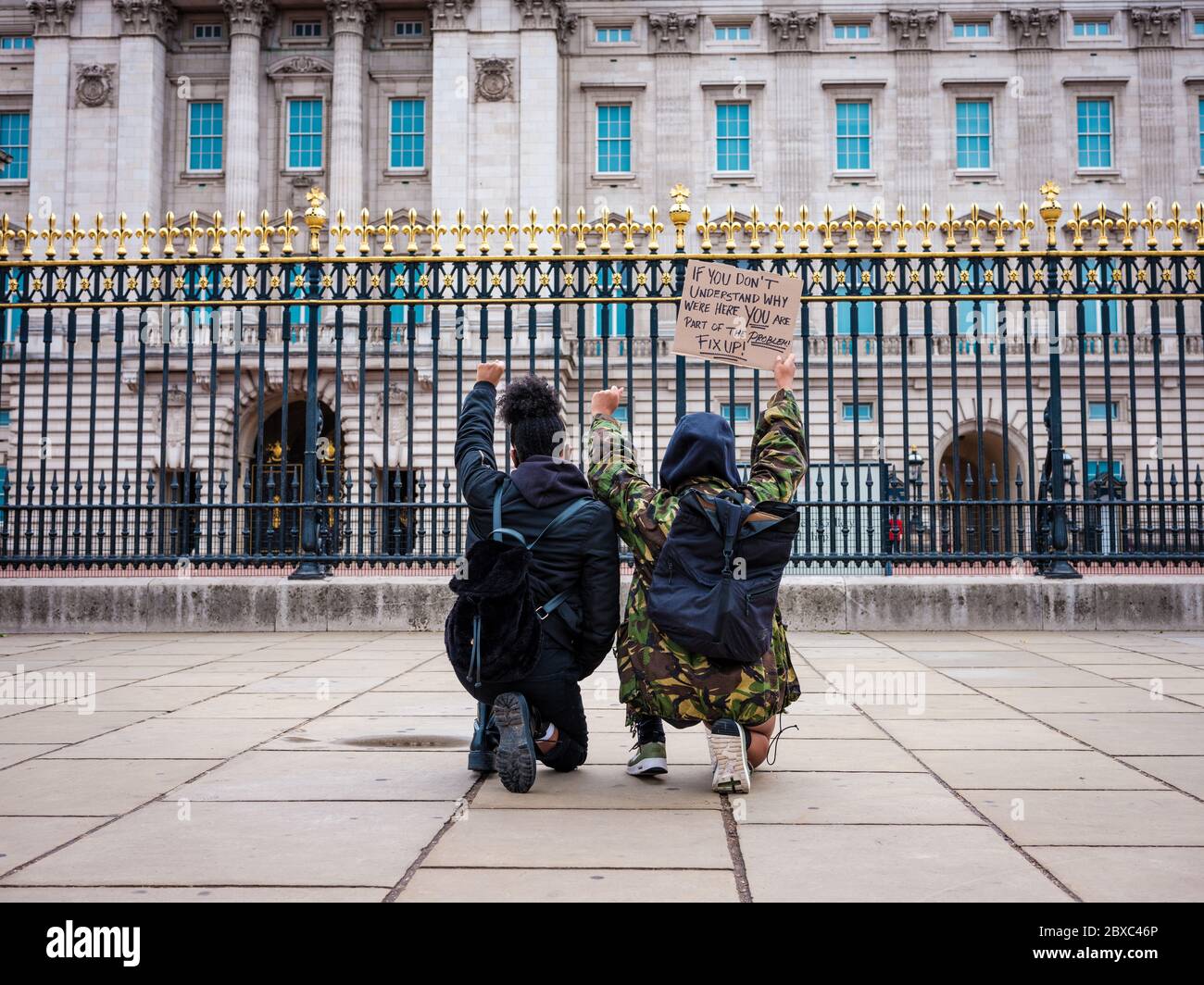 London Uk 6th June 2020 Two Ladies Take The Knee Outside Buckingham Palace During The Black Lives Matter Protest In In London In Memory Of George Floyd Who Was Killed On The