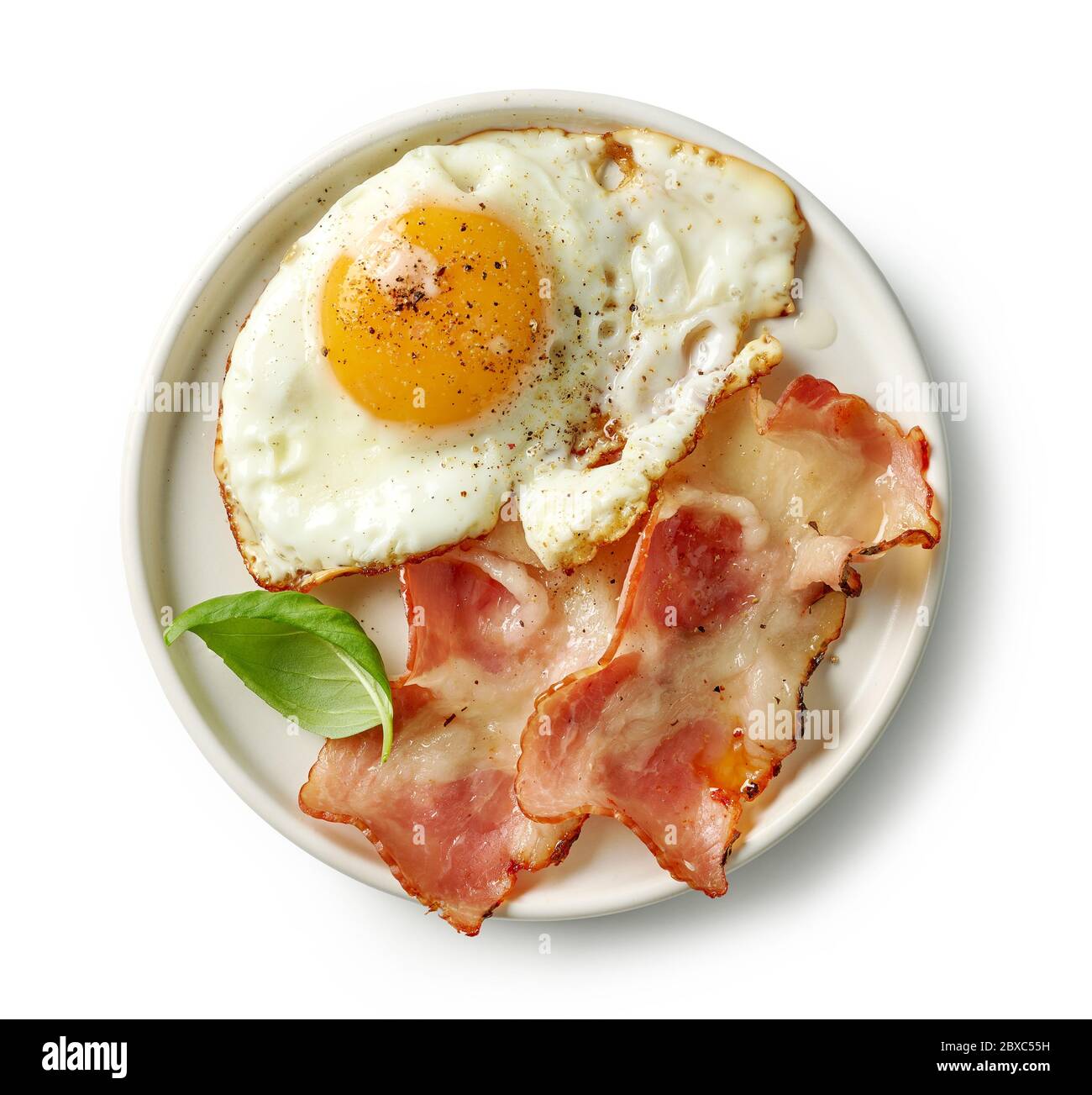 plate of fried egg and bacon isolated on white background, top view ...
