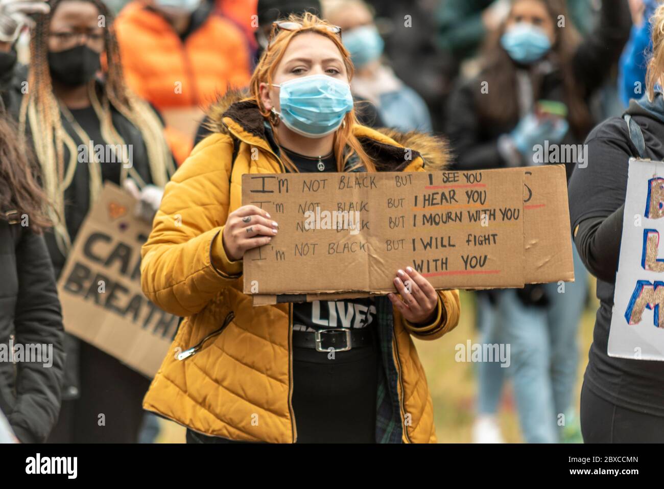 Black Lives Matter anti racism protest demonstration in Southend on Sea, Essex, UK. White Caucasian female with supporting slogan placard. Support Stock Photo