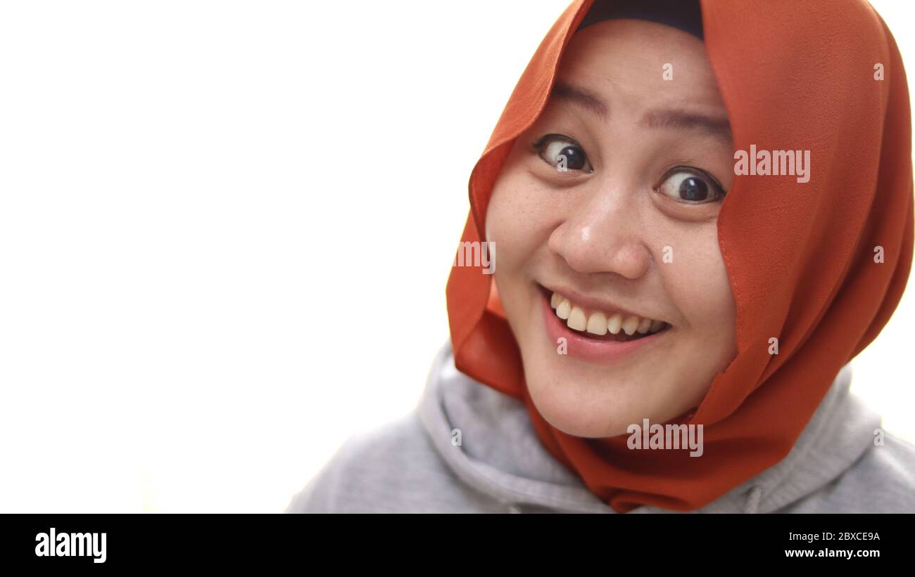 Happy Asian muslim woman smiling cheerful while looking at camera ...