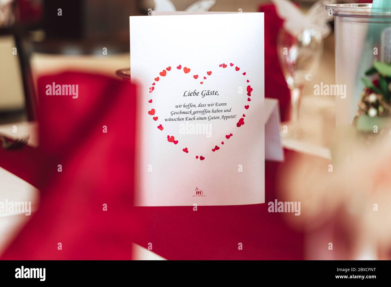 Welcome card with red heart symbol standing on table. wedding concept Stock Photo