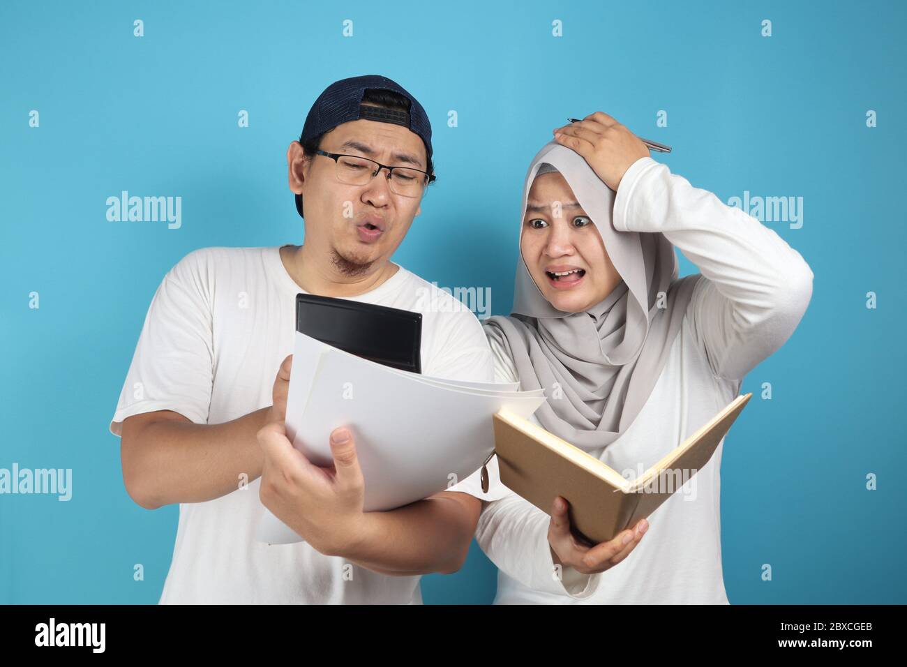 Portrait of Asian young muslim couple checking analyzing their family financial management report, young family housband and wife confused to have bad Stock Photo