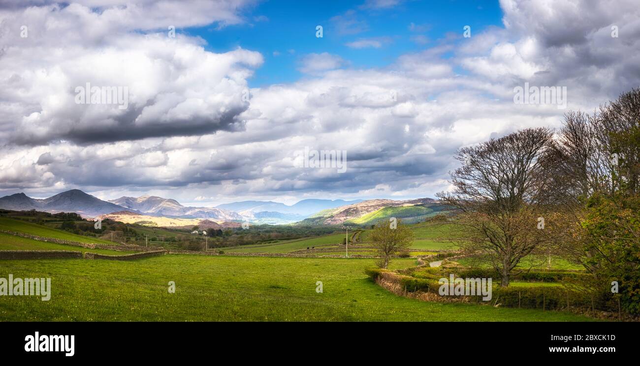 Looking across the valley from Hawkswell towards Lowick and on to the Coniston Fells with Coniston Water nestled just visible in the valley bottom. Stock Photo