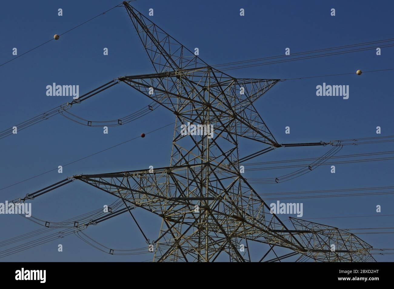 high voltage electric tower line with blue sky background Stock Photo ...