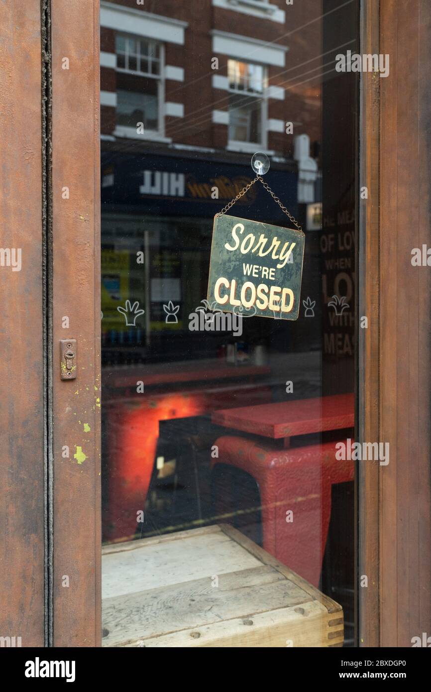 Sorry we are closed signage behind the locked doors of a shop at Strutton Ground Market, Victoria Stock Photo