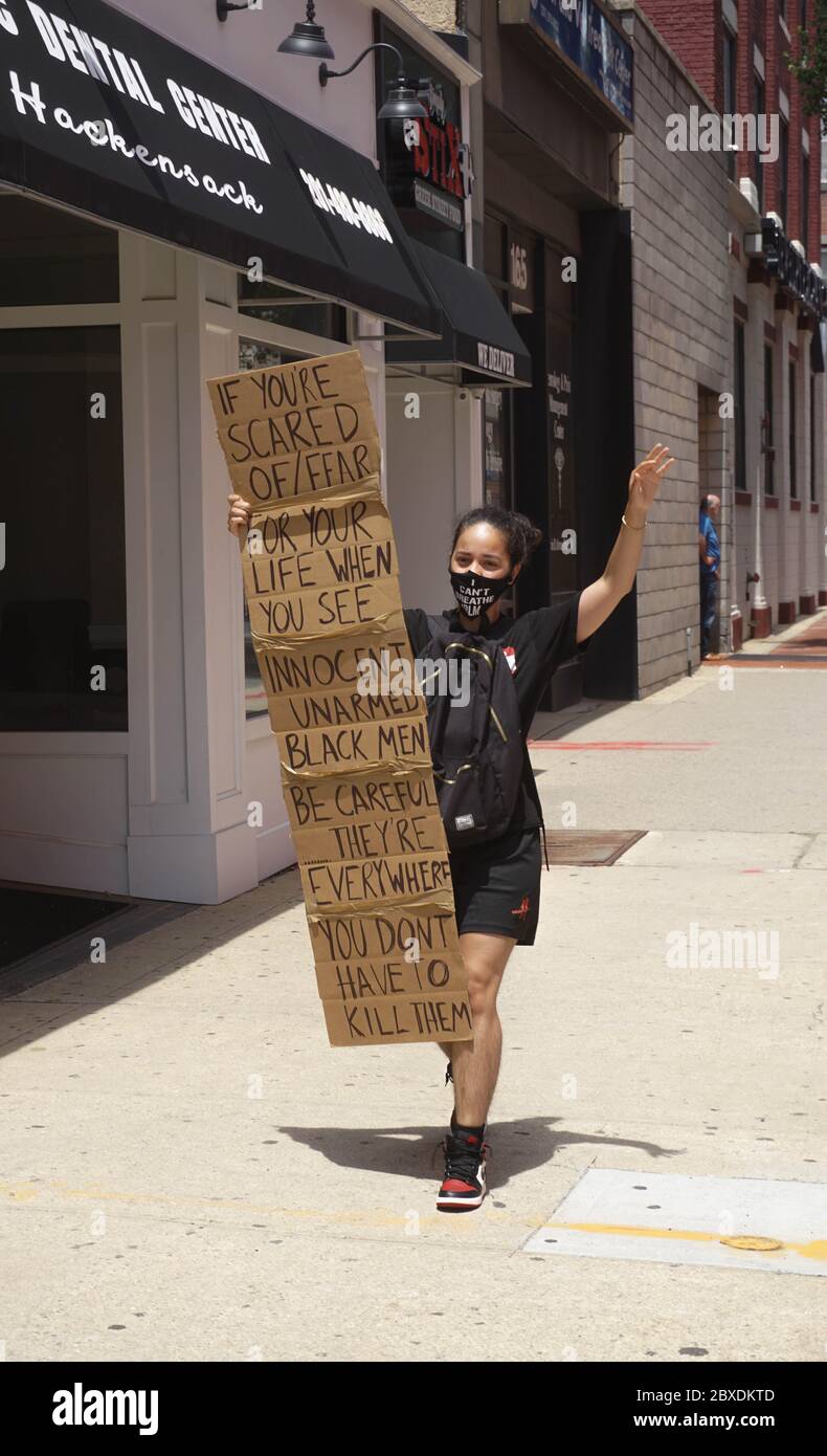 George Floyd Protest - Black Young Girl Walking Holding Sign - Hackensack, New Jersey, USA - June 6th, 2020 Stock Photo