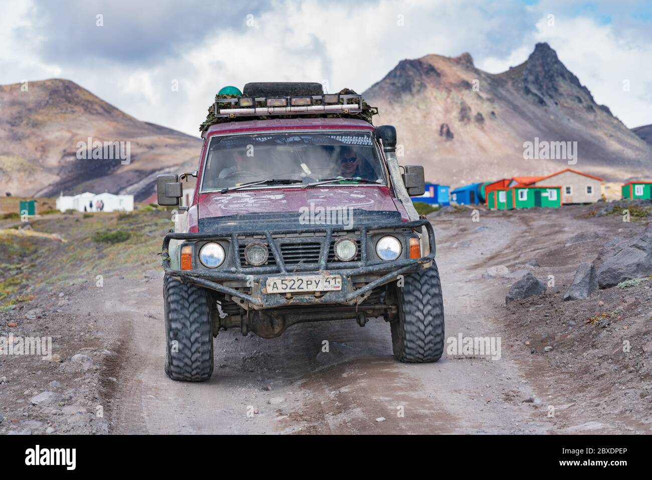 Japanese sport utility vehicle Nissan Patrol driving on rocky mountain