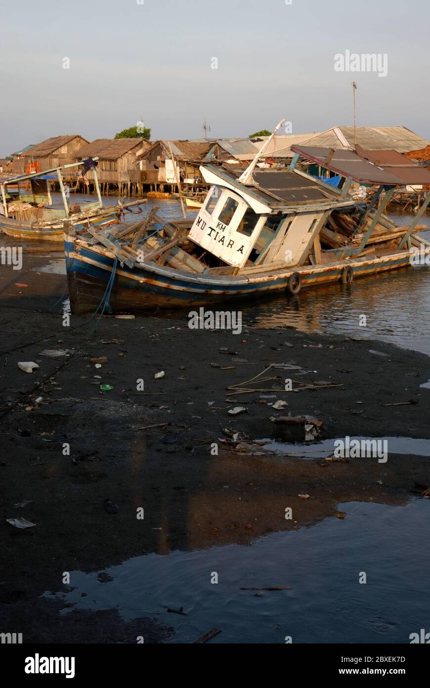 A fishing boat stranded on the intertidal area close to Marunda fishing village in North Jakarta, Special Capital Region of Jakarta, Indonesia. Stock Photo