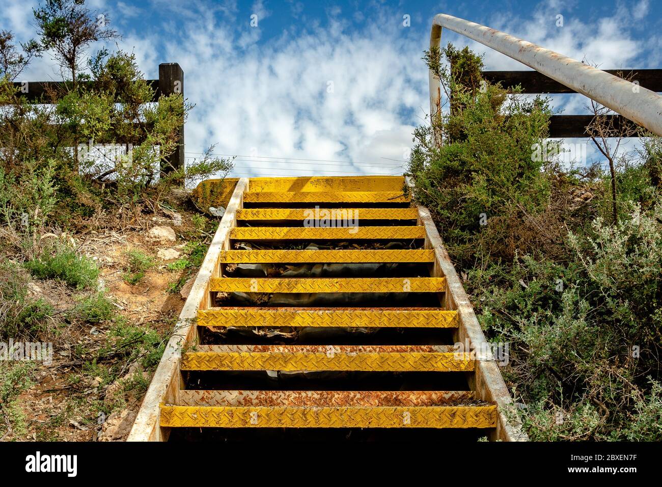 Up top view at the yellow metal stairs leading to the top Stock Photo