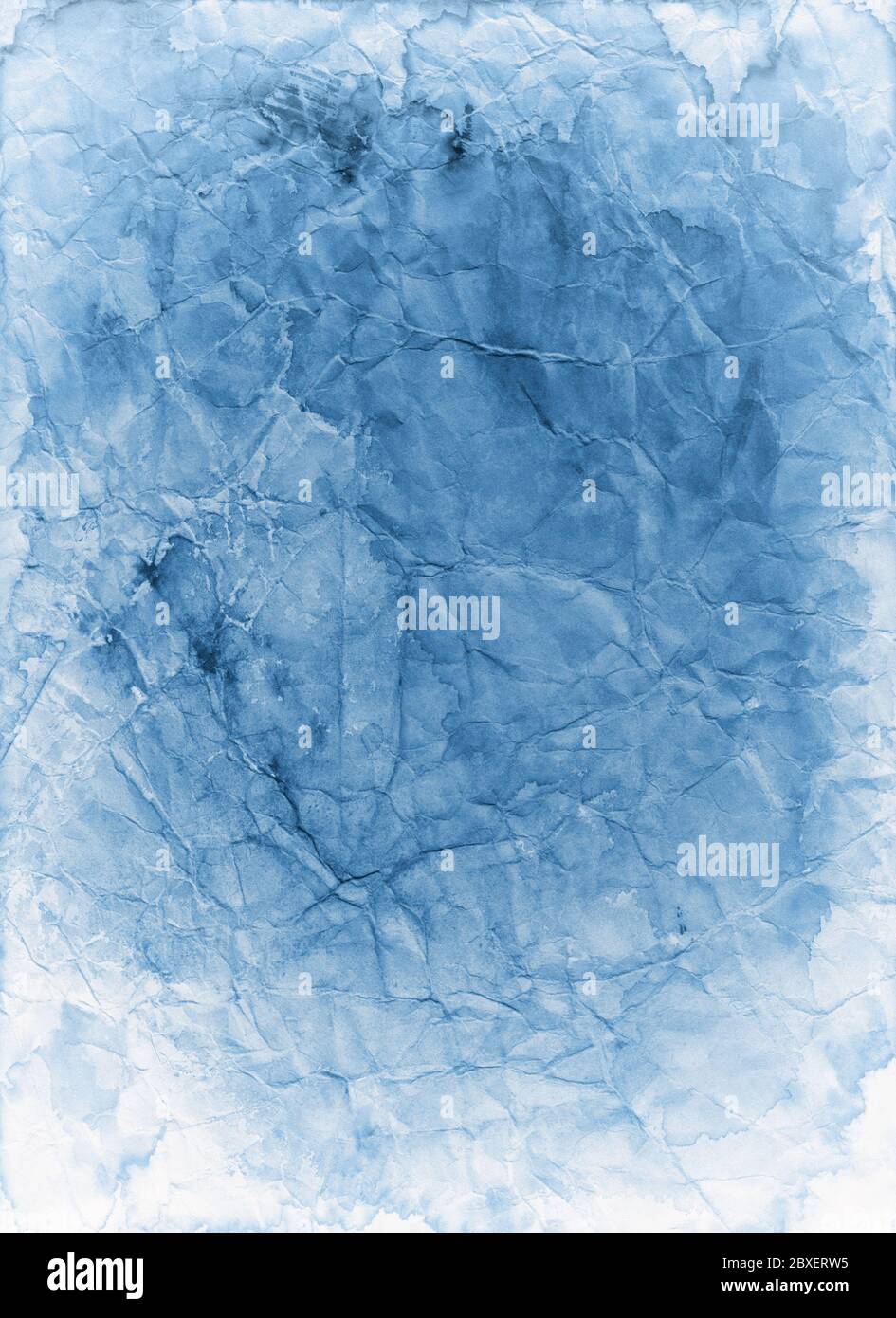 Old blue paper background texture that is faded stained and crumpled in