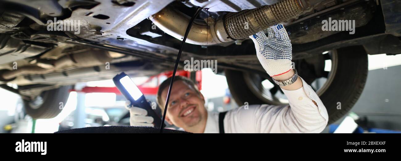 Mechanic conducts thorough inspection car garage. Stock Photo