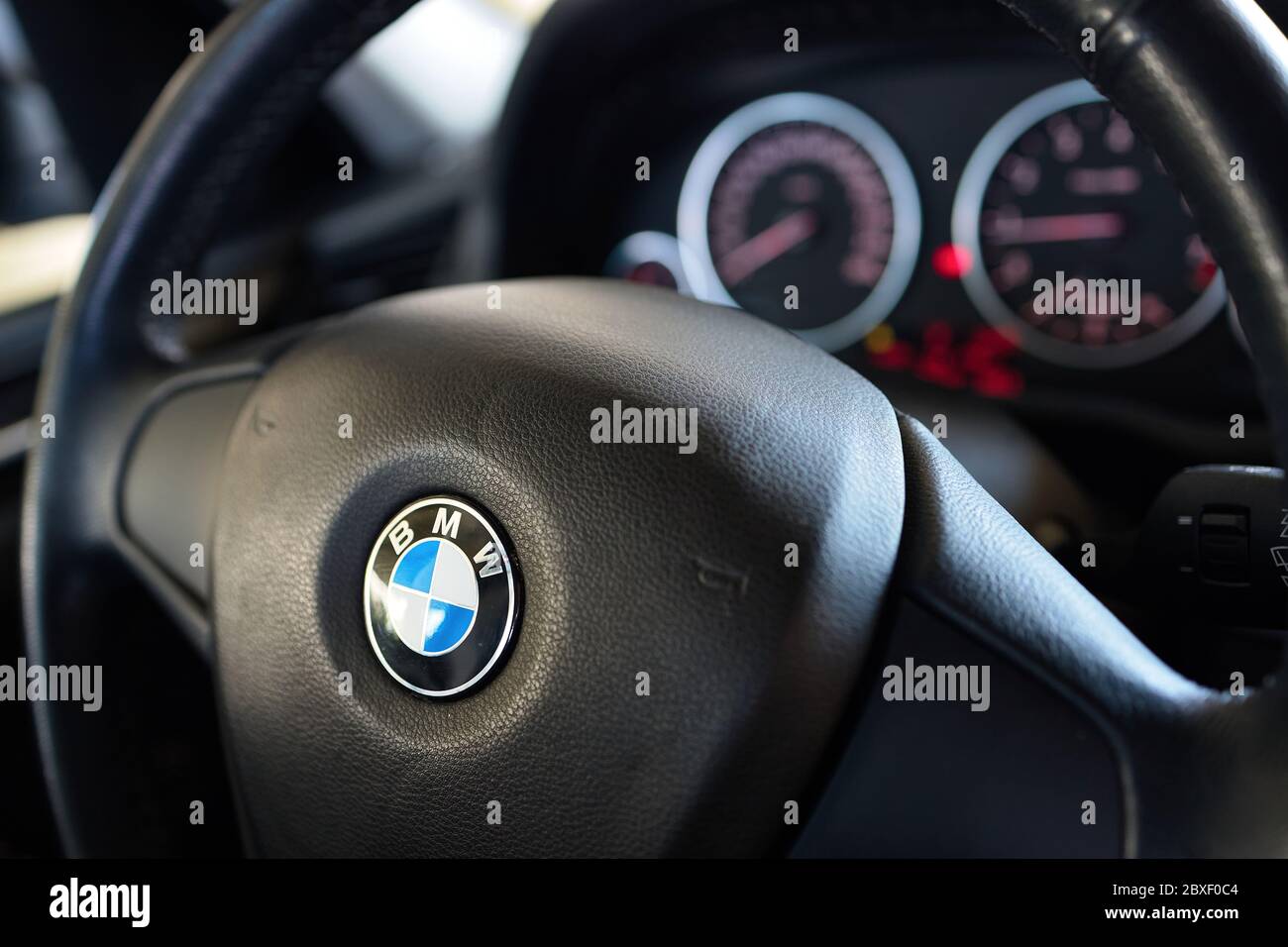 GRODNO, BELARUS - JUNE 2020: BMW X3 II F25 2.0i xDrive steering wheel with airbag and BMW logo with electronic dashboard, out of focus. Stock Photo