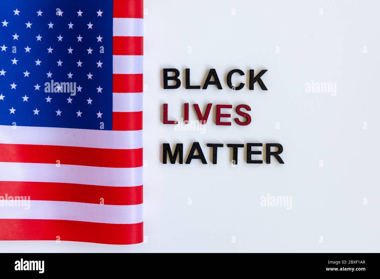 Close up Slogan Black lives matter tag. Black clenched protest. American Flag. Stock Photo