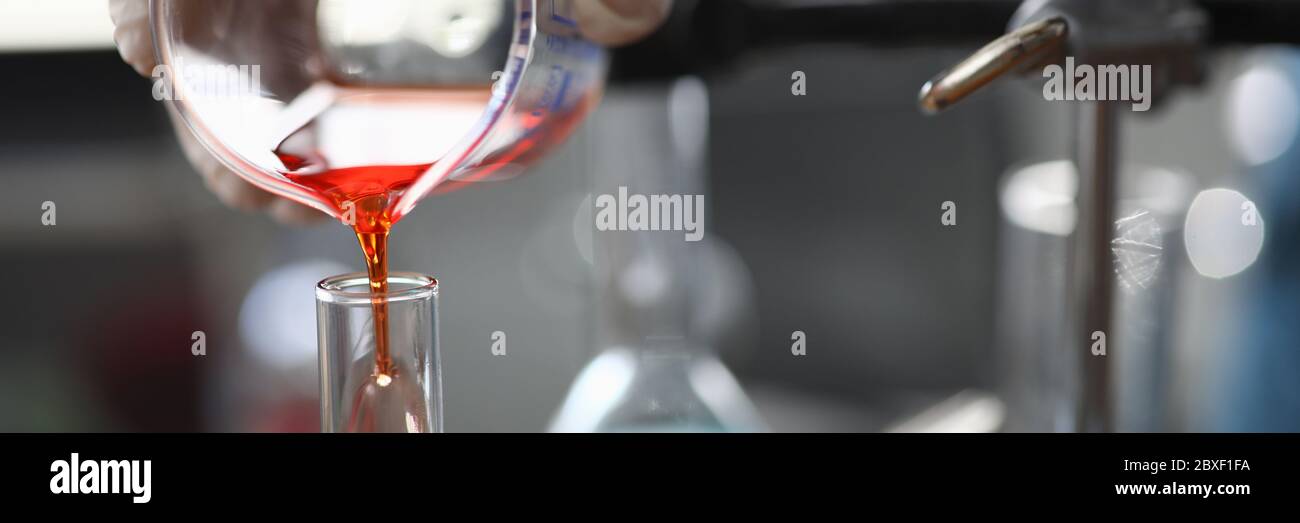 Chemical experiments with colored liquid in lab Stock Photo - Alamy