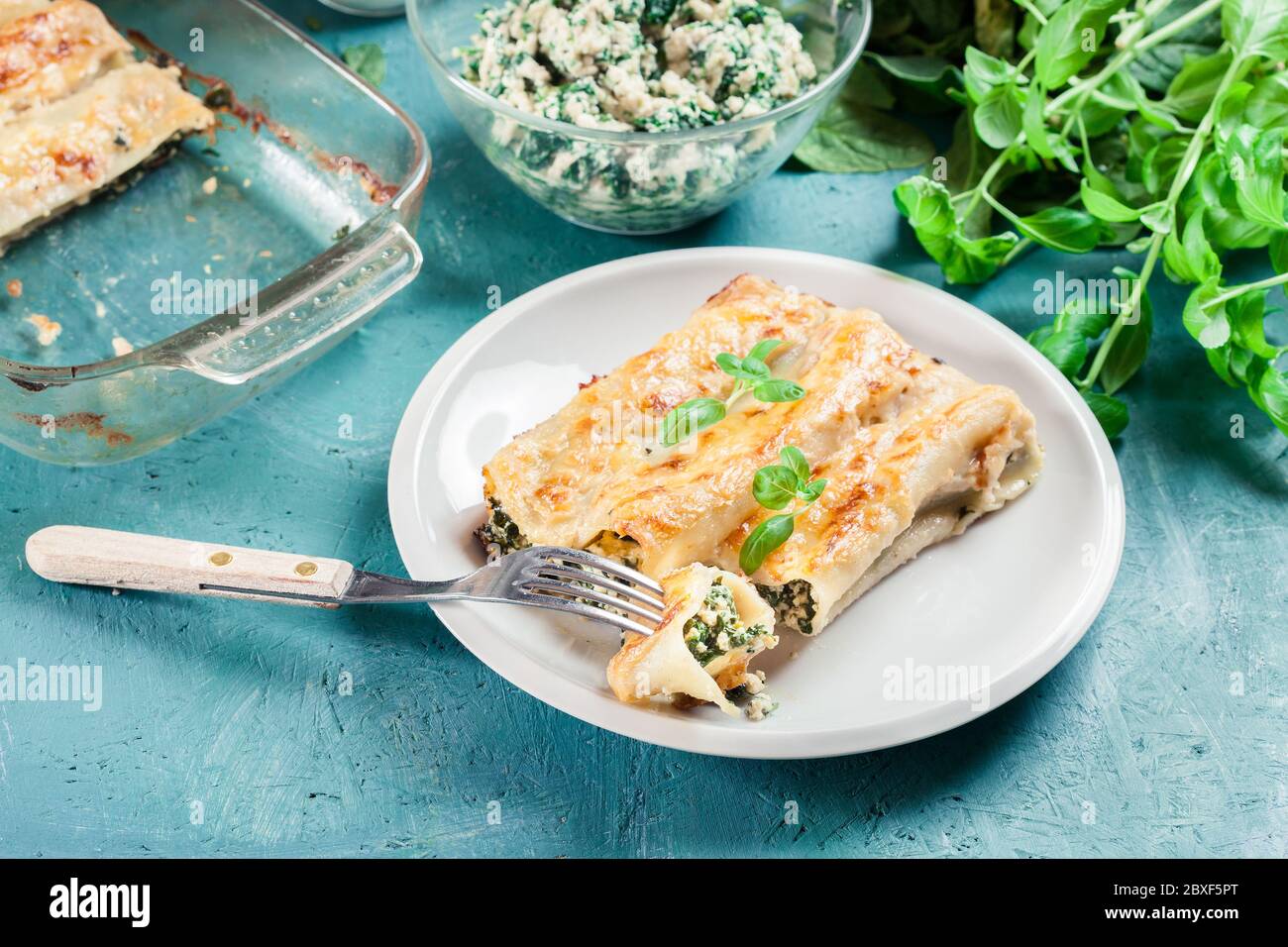 Portion of cannelloni stuffed with spinach and ricotta. Italian cuisine Stock Photo