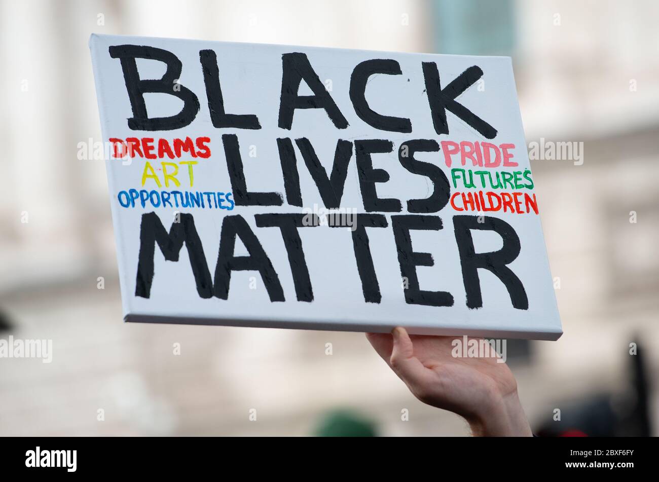 Protester holding up campaign / supportive poster/ sign, at the London Black Lives Matter protest demonstration in Parliament Square. Stock Photo
