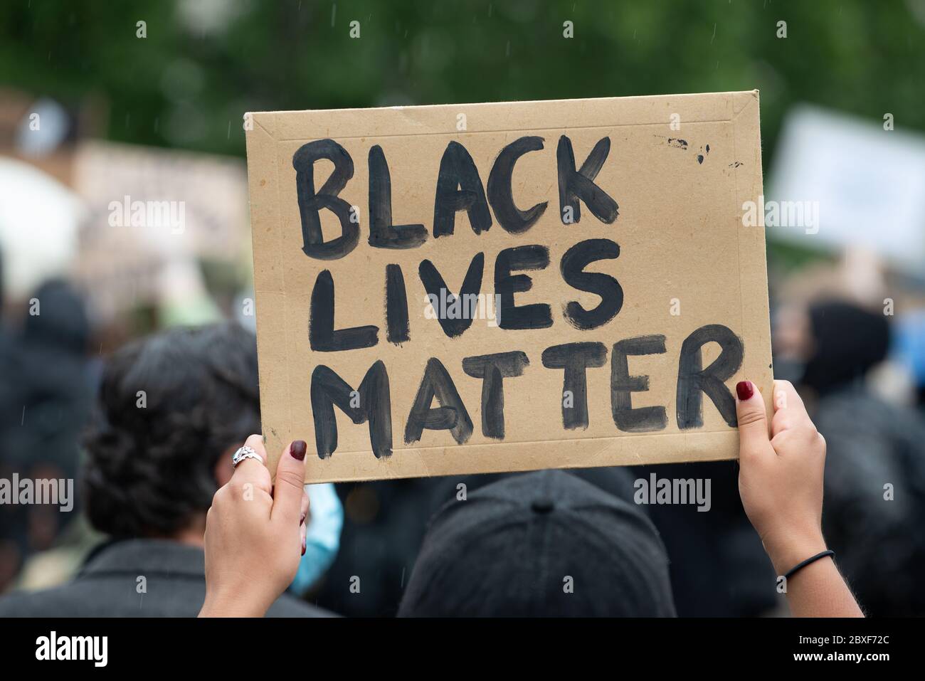 Protester holding up campaign / supportive poster/ sign, at the London Black Lives Matter protest demonstration in Parliament Square. Stock Photo